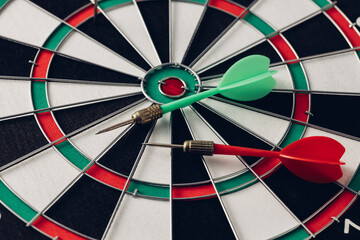 Colorful darts on a classic dartboard target close-up view