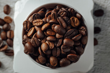 Freshly Roasted Coffee Beans in White Bowl on Light Surface
