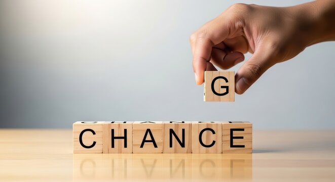 Hand positioning a wooden block to complete the word 'CHANGE' from 'CHANCE', representing strategic adaptability, seizing growth opportunities, and successful business transformation