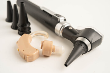 Otoscope isolated on white background for otolaryngologist or ENT physician doctor examining senior patient ear, hearing loss problem.