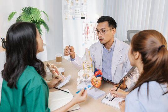 Group of doctors and nurses consulting about a complex patient case in hospital office. Team analyzing medical data and discussing diagnostic plans for accurate and efficient treatment.