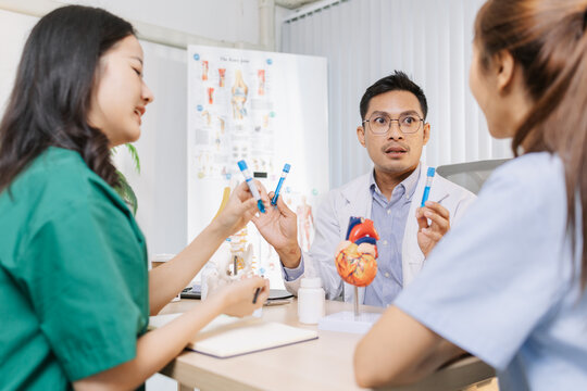 Group of doctors and nurses consulting about a complex patient case in hospital office. Team analyzing medical data and discussing diagnostic plans for accurate and efficient treatment. - Powered by Adobe