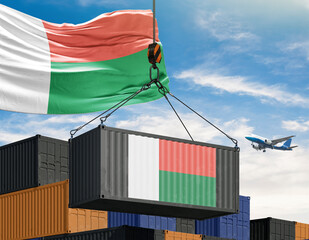 Madagascar's Trade: A shipping container, adorned with Madagascar's flag, is hoisted by a crane against a backdrop of the sky, symbolizing trade, transport, and international commerce. 