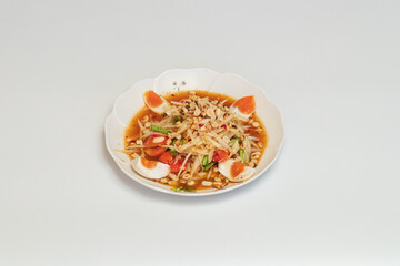 Green papaya salad Thai cuisine spicy delicious. Thai call "SOM TAM". Famous Thai food, papaya salad, Somtum, Papaya Pok Pok. Closeup Thai Green Papaya Salad with peanuts.