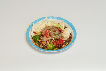 Green papaya salad Thai cuisine spicy delicious. Thai call "SOM TAM". Famous Thai food, papaya salad, Somtum, Papaya Pok Pok. Closeup Thai Green Papaya Salad with peanuts.