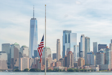 View of The American Flag - at Half Mast - Juxtaposed next to One World Trade Center, in Honor of The Twin Towers and the 9/11 Tragedy © Oliver Perić