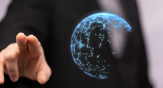 Close up of a businessman touching a holographic projection of a digital network globe. Concept of global network, connection, innovation and te