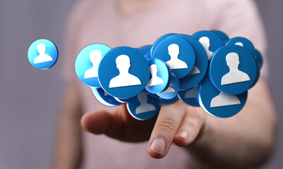 A person's hand interacts with a digital illustration of user icons representing network and connections, highlighting social media and communit