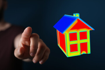 A person points at a digital house model, symbolizing concepts like real estate, home ownership, future planning and virtual technology. Ideal f