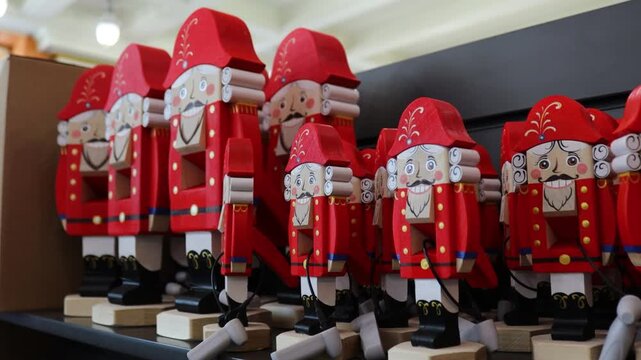 Row of wooden nutcrackers displayed on a shelf, ideal for decorating homes and businesses during the holiday season