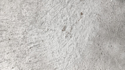 closeup of a rough weathered light gray concrete or cement wall floor texture with abstract patterns. Concepts of industrial background grunge surface construction material and exterior design.