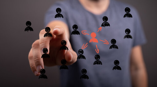 Hand pointing at a central person, symbolizing leadership, team selection, and influence.