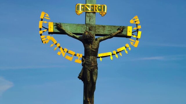 Holy Crucifix Calvary Statue Charles Bridge Prague Czech Republic Golden Hebrew Inscription Baroque Religious Art Cinematic 4K B-Roll Footage Icon