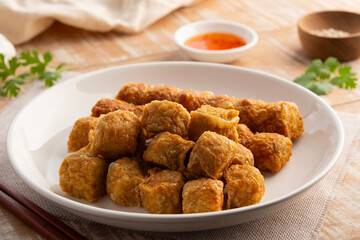 Deep Fried Chicken Rolls in white plate.with chilli sweet sauce.(Hoi Jo)