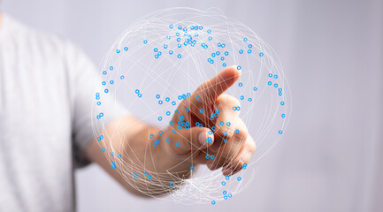 A person's finger interacts with a digital sphere representing global connection and technology. Ideal for concepts of communication