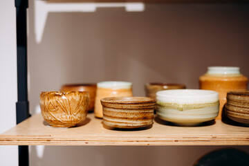 Handmade ceramic match holders on store shelf close-up.
