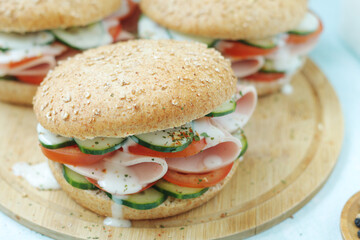 Bun sandwiches with salami and vegetables	
