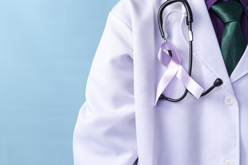 A doctor is wearing a pancreatic or a testicular cancer ribbon on an isolated background