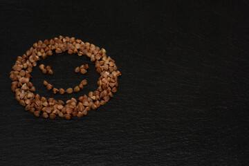 The photo shows buckwheat groats in the form of a smiley face.