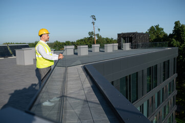 Man standing confidently near renewable energy installation