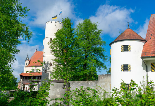 Mindelburg Castle in Bavaria with Flags Flying on the Tower in a Scenic Historic Landscape with flags flying atop its tower, captured in a scenic historic setting with bright daylight 