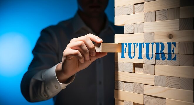 Man carefully removes a wooden block from a tower, revealing the word future in blue stencil