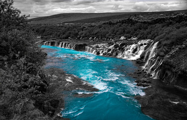 Hraunfossar Cascades, rapids and waterfalls are a unique natural wonder in Iceland with water...