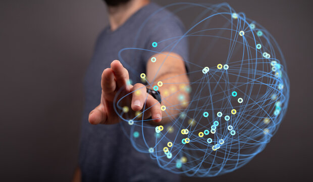 Abstract image showing a person interacting with a futuristic, interconnected network globe. Perfect for technology, communication and global co - Powered by Adobe