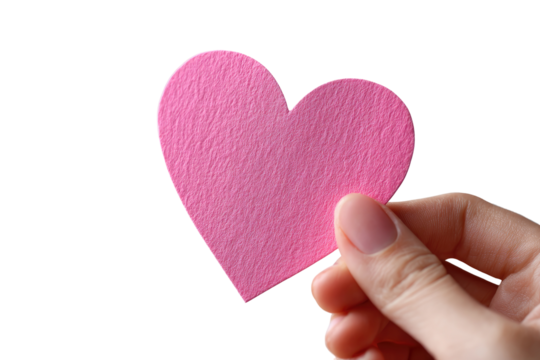 A pink heart-shaped paper cutout held gently by a hand