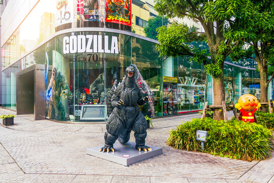 Tokyo, Japan - November 15, 2024: Human-sized Godzilla character statue outside a store in Tokyo, Japan, celebrating the monster's 70th anniversary. 