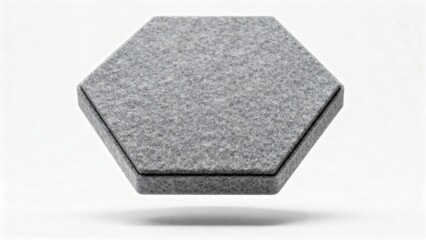 A gray hexagon shaped object with a textured surface floating above a white surface in a studio shot