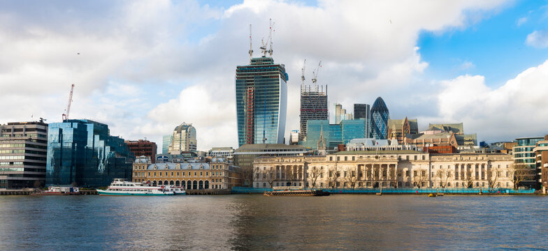 River Thames and the North Bank skyline, buildings of the City of London, a historic waterfront with modern buildings of the financial downtown district behind. 