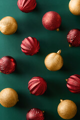 Christmas decoration ornaments on green background viewed from above. Top view