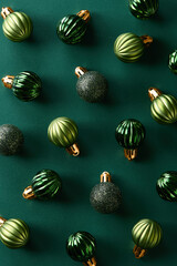 Christmas decoration ornaments on green background viewed from above. Top view