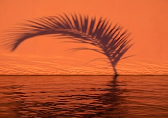 Tropical Sunset with Palm Leaf Shadow over the Ocean creating a Monochromatic Orange Scene