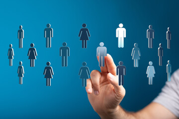 Hand touching human figures on a blue background, representing connection, community and social interaction. Co