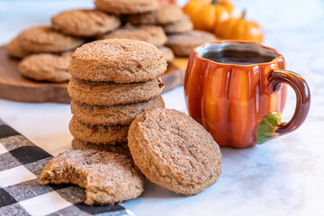 Delicious homemade cookies and warm coffee served in a cozy autumn setting with pumpkin decorations