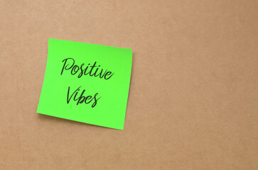 Positive Vibes Handwritten Note: A simple yet powerful message of optimism written in black text on a note, serving as a daily reminder for happiness.
