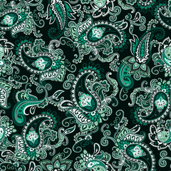Seamless green and black paisley pattern on a dark forest green background. Traditional batik flower motif for textile fabrics.