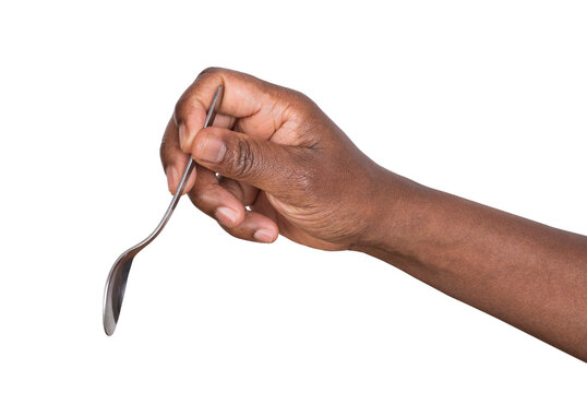 Hand holding a steel teaspoon isolated on white or transparent background 