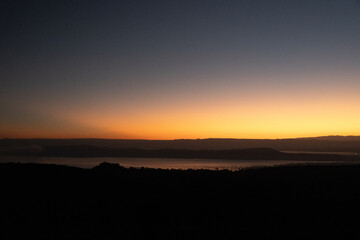 Golden sunrise over Lake Nakuru and the Great Rift Valley with a silhouette of distant hills Kenya