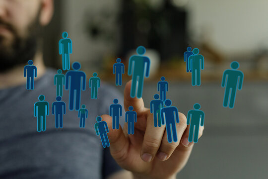 Concept of social networking, global communication and people connections. Digital hand pointing at virtual peo