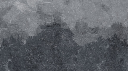 Dark grey stone surface with rough textured patterns creating a natural abstract rock background.