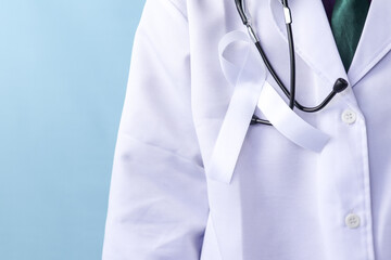 A doctor is wearing a lung cancer ribbon on an isolated background