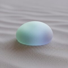 Softly lit abstract oval with a pastel color gradient resting on a subtle wavy grey texture