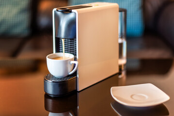 Morning fragrant coffee with coffee machine. Espresso coffee machine which make the cup of morning coffee, cosy living room background