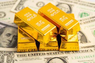 Gold bars on US dollar banknote money, finance trading investment business currency.