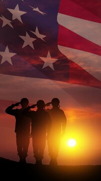 Silhouettes of soldiers saluting on background of sunset or sunrise and USA flag. Veterans Day, Memorial Day, Independence Day. Vertical video for social media and stories.