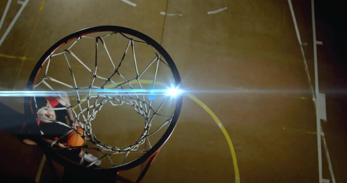 Male player entering from left, jumping beside rim, powering dunk with ball, scoring for sports