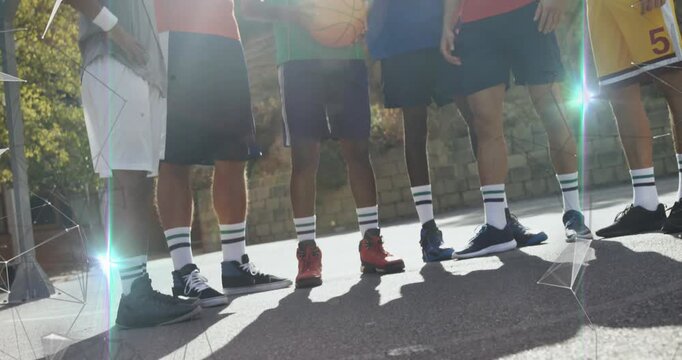 Camera tilting up after player bringing basketball forward, six men lining up for sports portrait